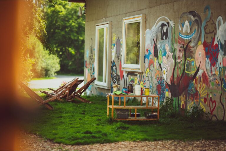 Outdoor wall painting at Mia Glamping in Saaremaa with colorful mural and seating area
